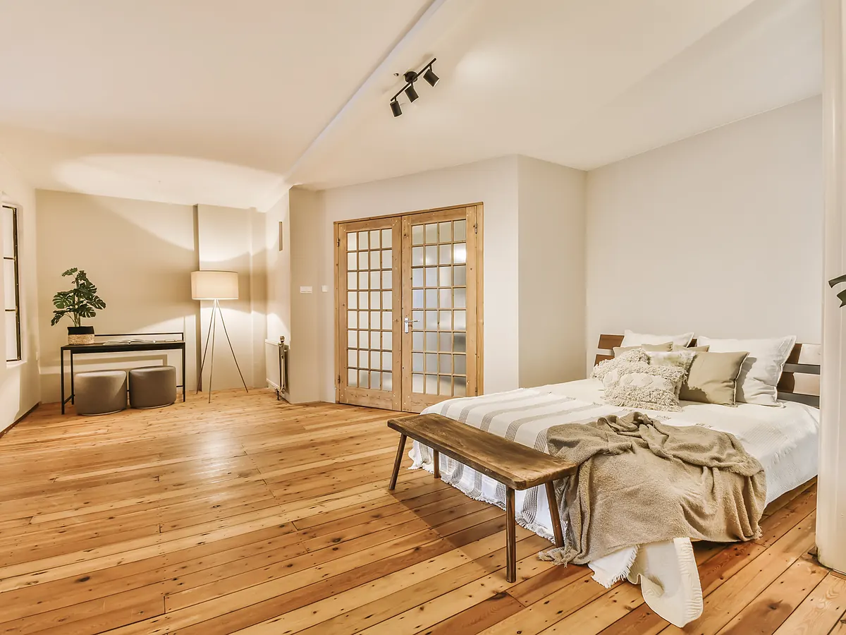 Warm wide-plank hardwood floor in a Sioux Falls, SD bedroom after a carpet-to-hardwood conversion
