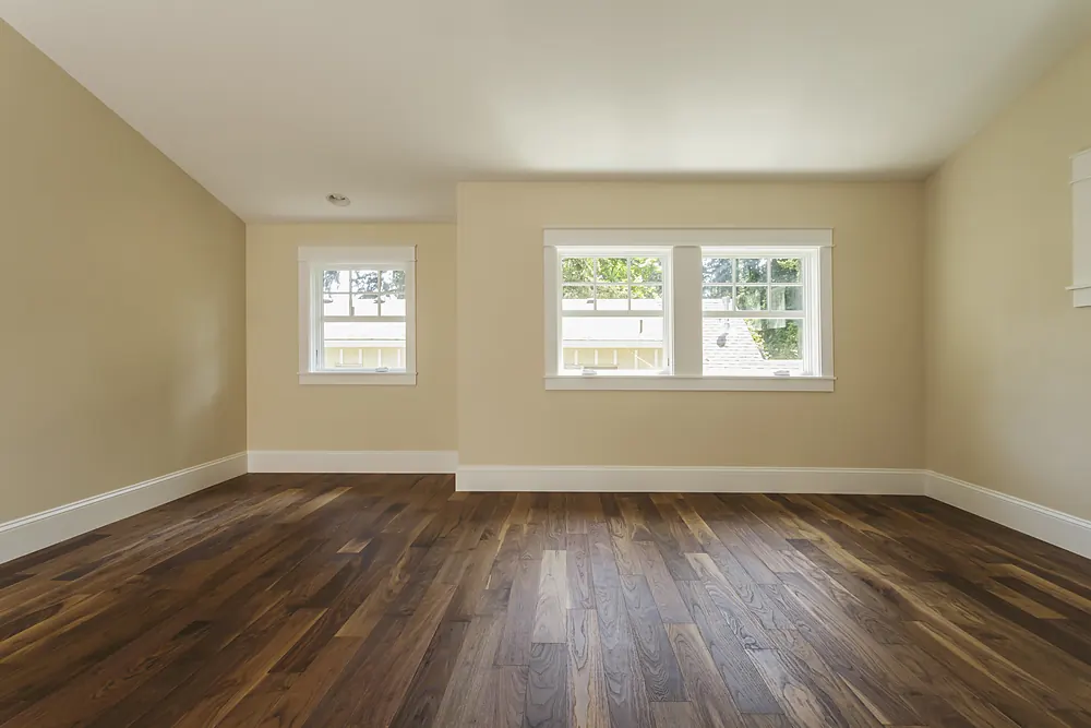 Dark walnut-toned hardwood floor in an empty Sioux Falls, SD room