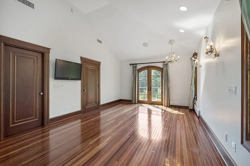 Glossy dark hardwood floor in a Sioux Falls, SD bedroom