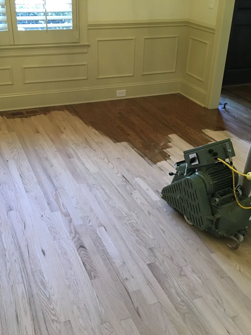 Drum sander taking a hardwood floor back to bare wood during a dustless refinish in Sioux Falls, SD
