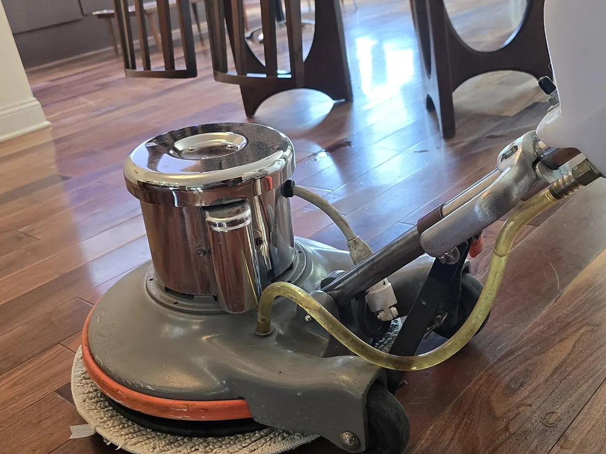 Screen-fitted buffer scuffing the old finish during a hardwood floor screen and recoat in Sioux Falls, SD
