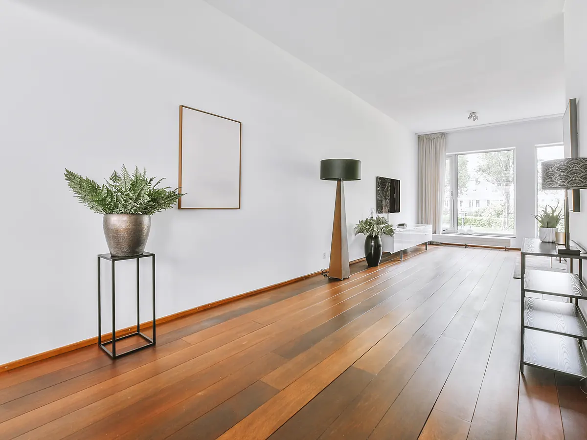 Site-finished hardwood floor sanded flat with tight, bevel-free seams in a bright Sioux Falls, SD room