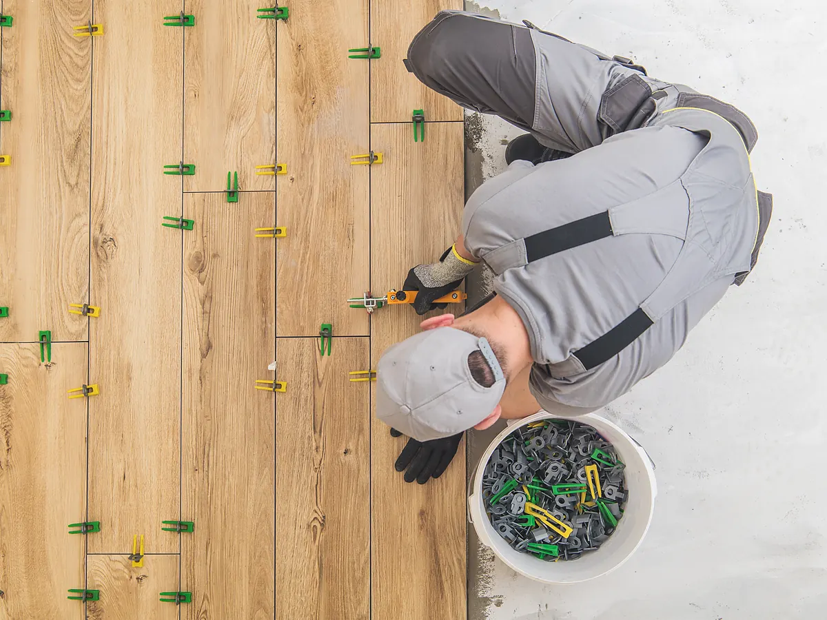 Wood-look porcelain tile set with leveling clips in a Sioux Falls, SD home